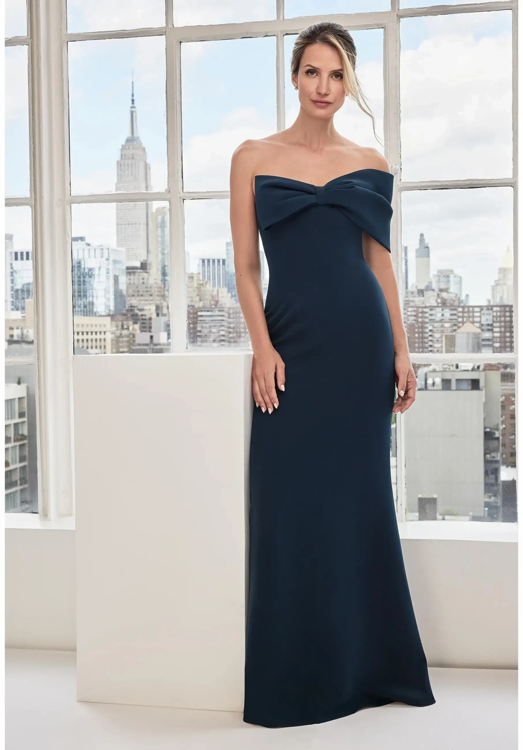 model is wearing a navy one shoulder evening gown