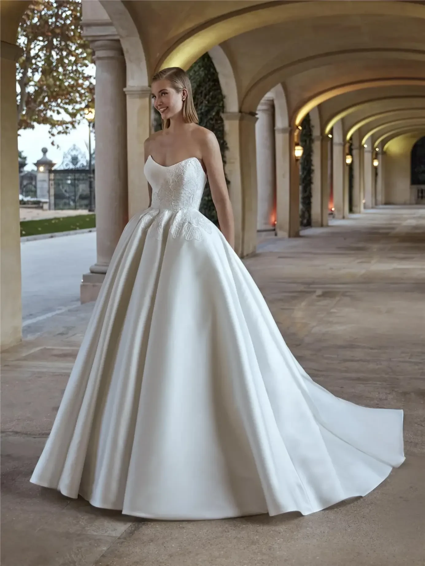 model is wearing a strapless ball gown