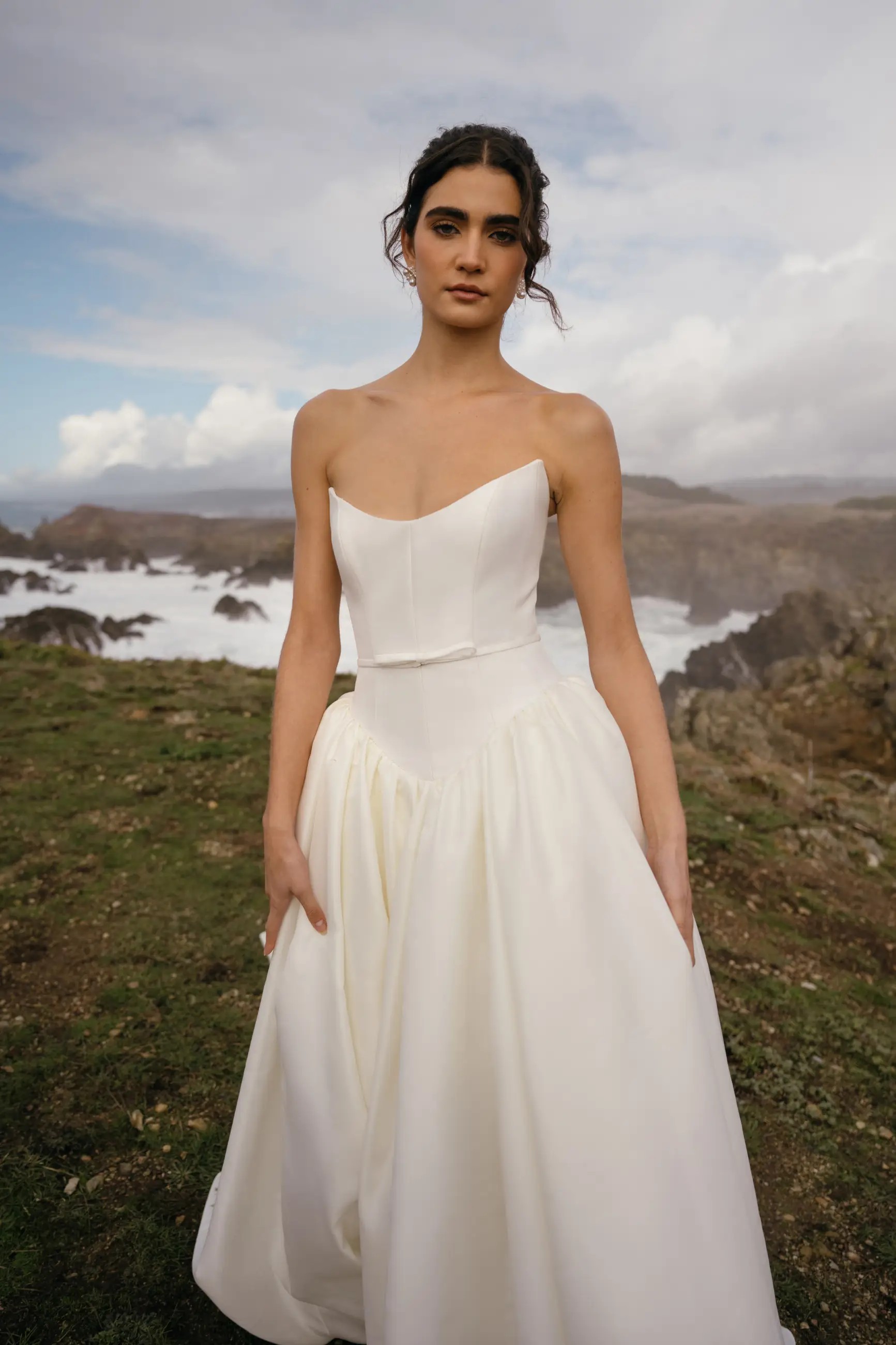 Model is wearing Danielle, a lightweight ball gown wedding dress with a strapless neckline and structured bodice by jenny yoo and hope lavine