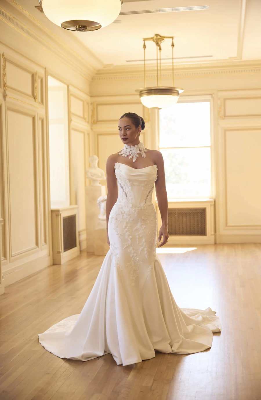model is wearing a strapless fit and flare wedding dress