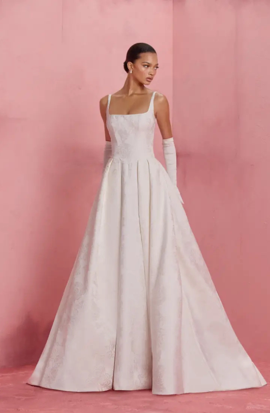 model is wearing a sleeveless square neck bridal gown