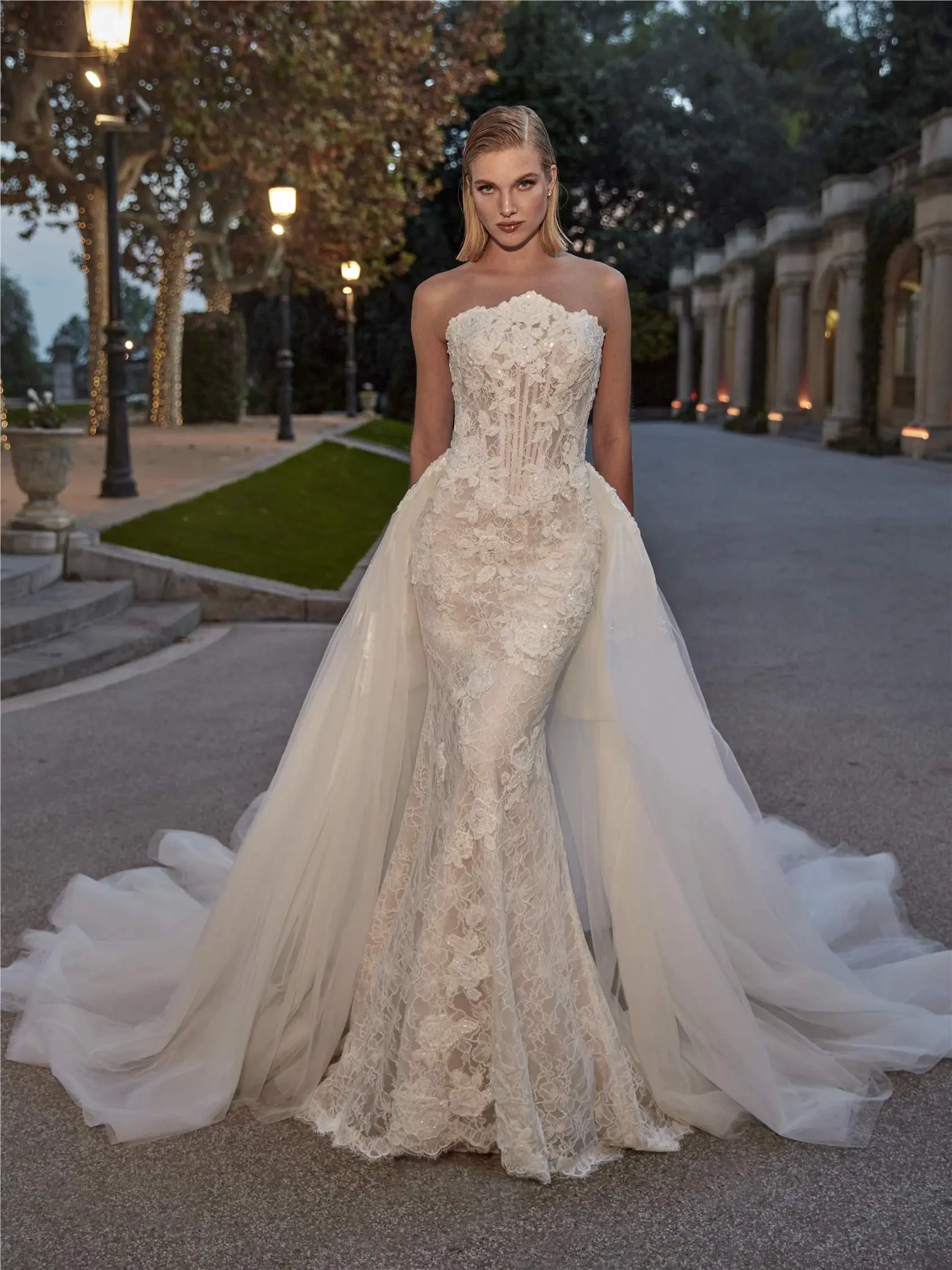 model is wearing a fit and flare wedding dress with a bold overskirt