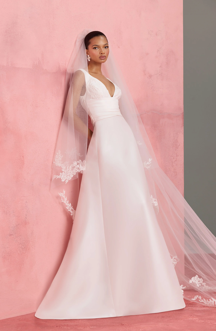 model is wearing a sleeveless v-neck wedding dress