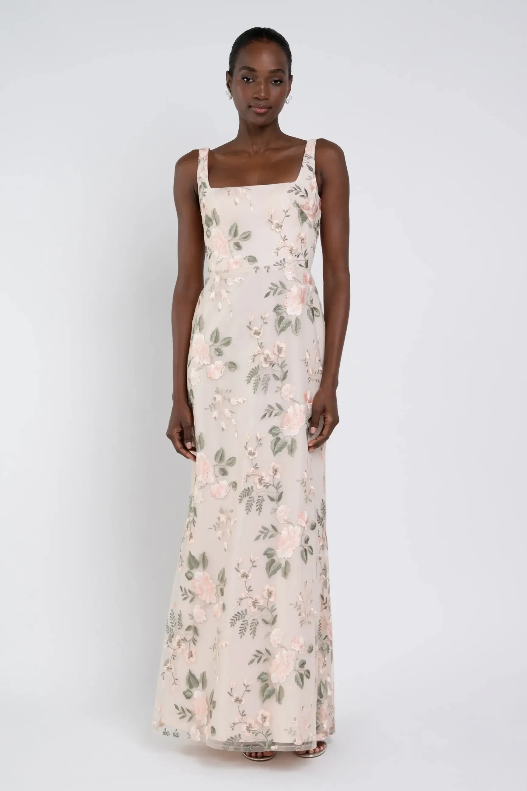 model is wearing a yellow floral bridesmaid dress