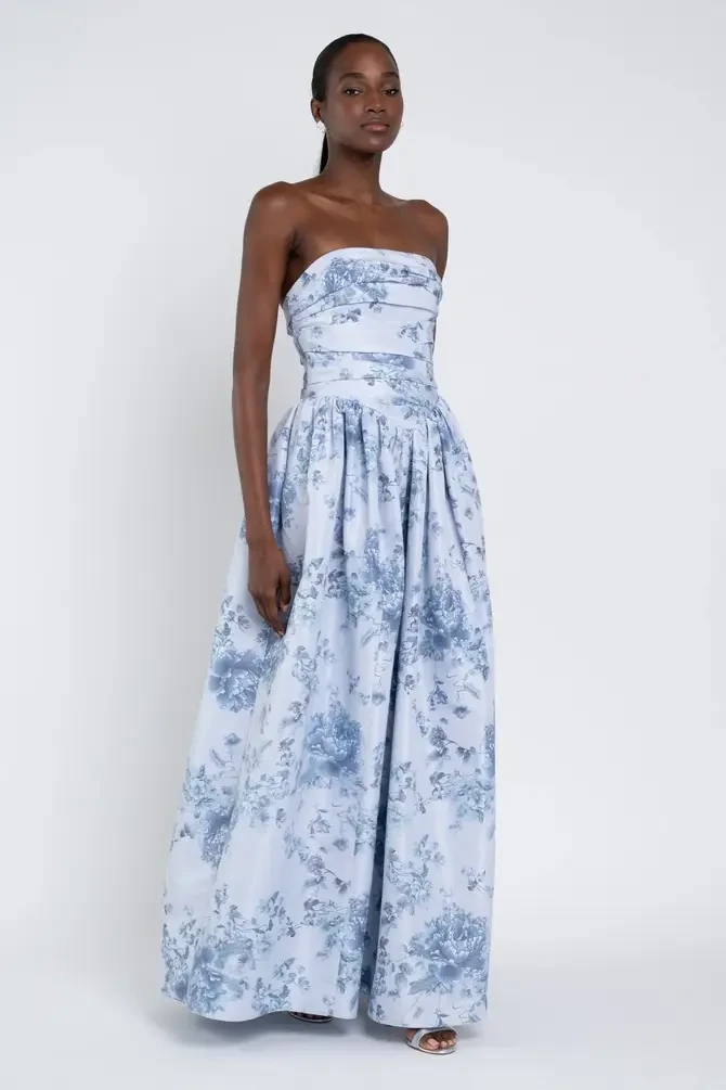 model is wearing a blue floral strapless bridesmaid dress