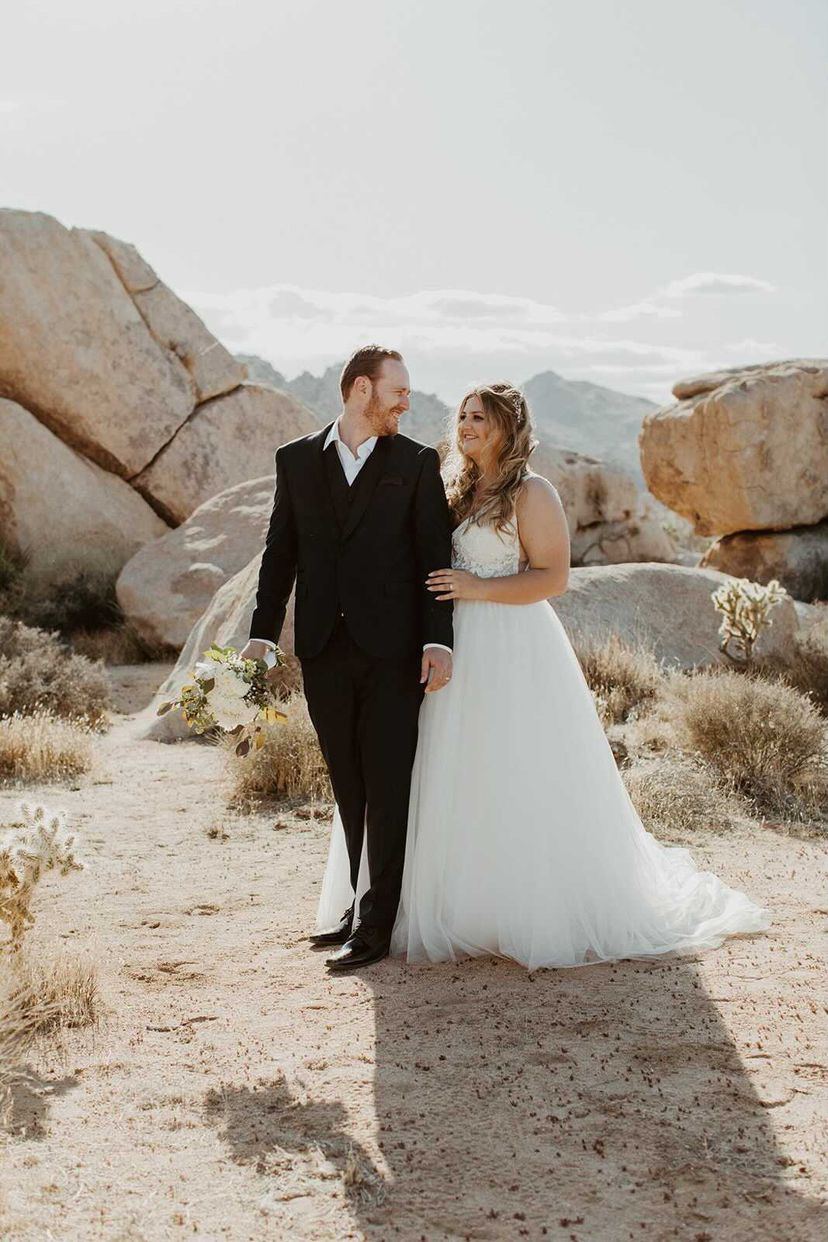 Сouple wearing a white gown and a black suit