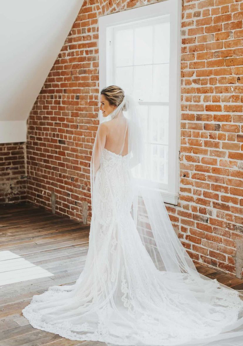 Modal wearing a white gown at home