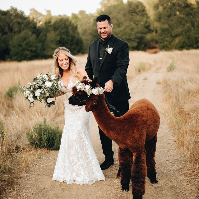 Сouple wearing a white gown and a black suit with a pony