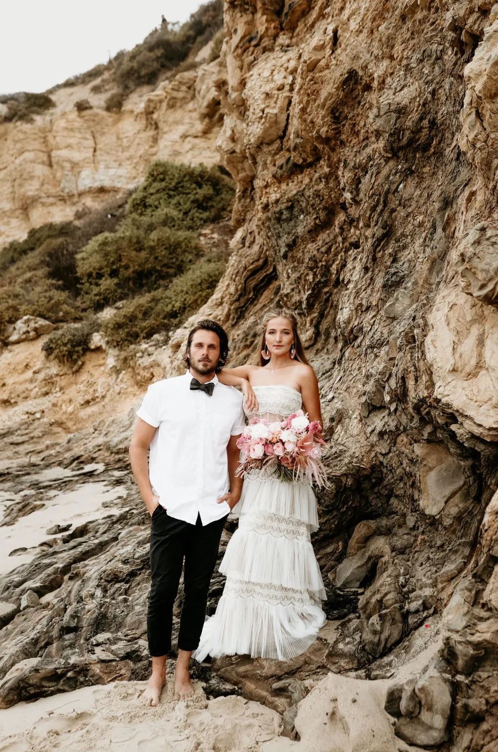 Сouple wearing a white gown and a white suit