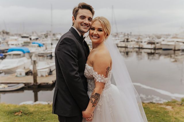 Smiling couple wearing a white gown and a black suit