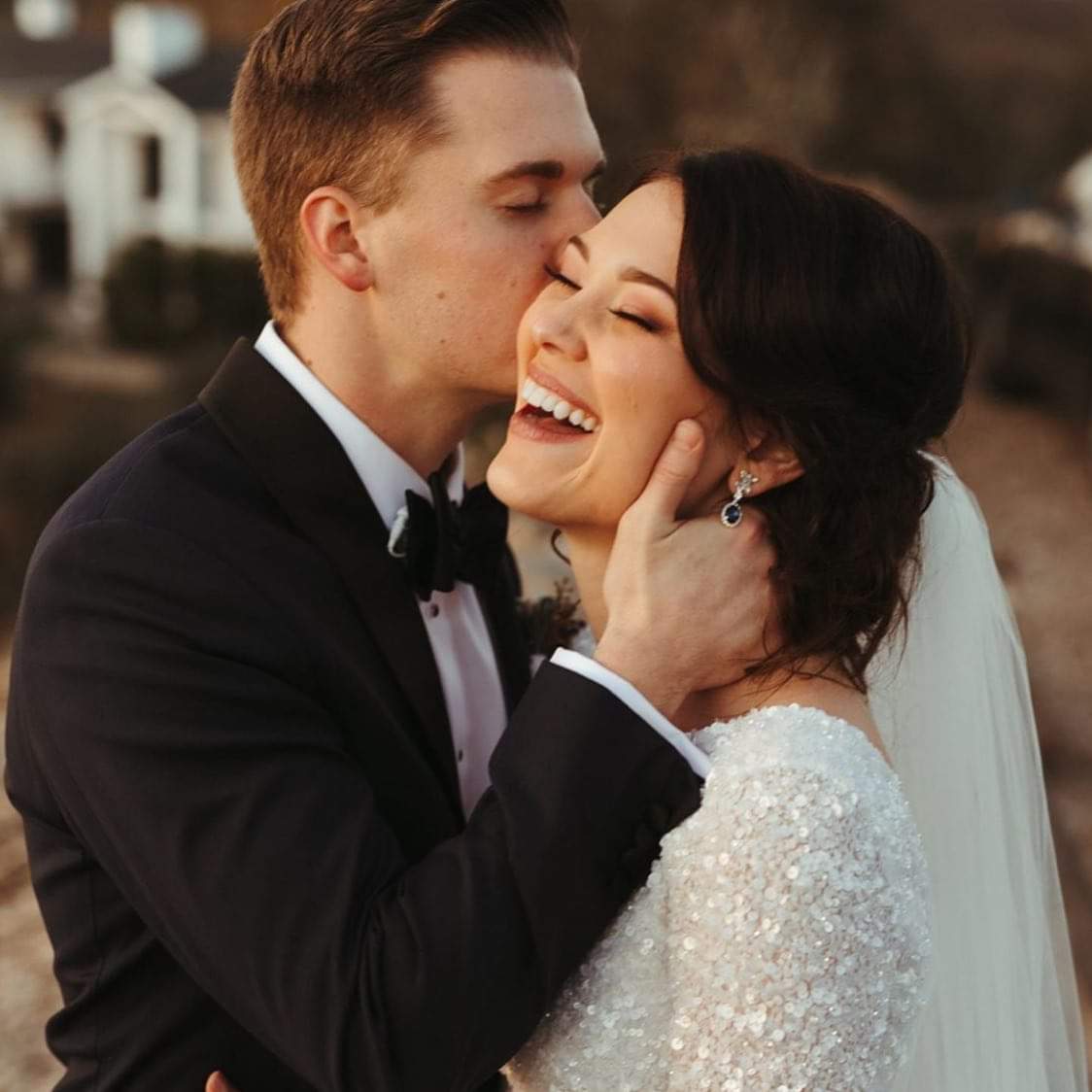 Smiling couple wearing a white gown and a black suit