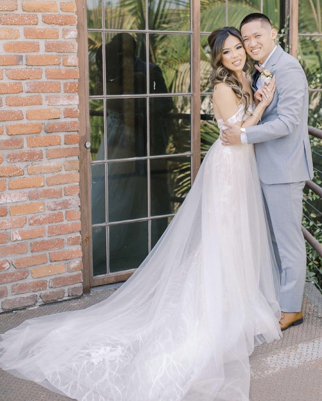 Сouple wearing a white gown and a light-gray suit