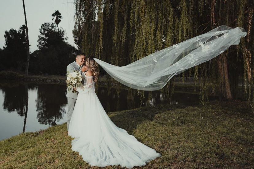 Сouple wearing a white gown and a white suit