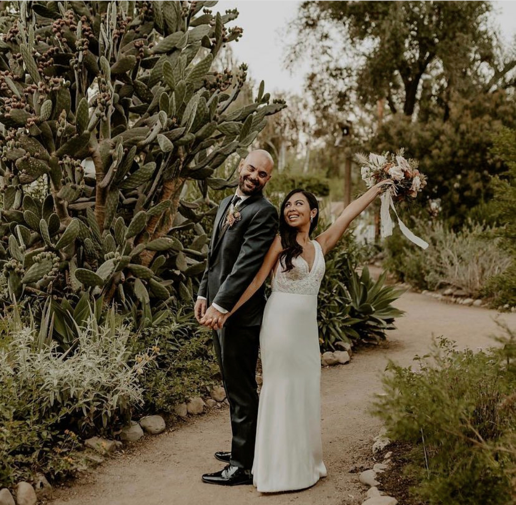 Сouple wearing a white gown and a gray suit