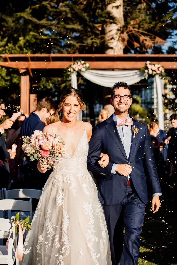 Сouple wearing a white gown and a dark-blue suit