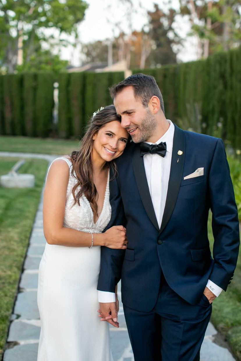 Сouple wearing a white gown and a dark-blue suit