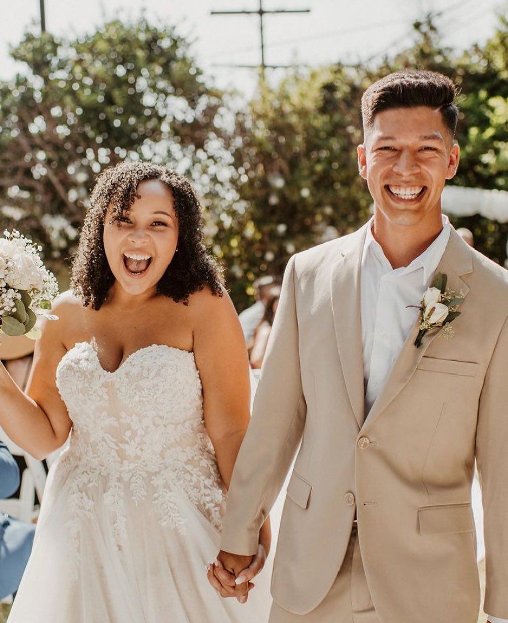 Сouple wearing a white gown and a white suit