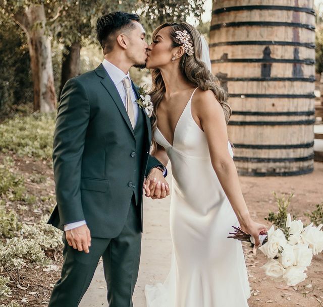 Сouple wearing a white gown and a gray suit