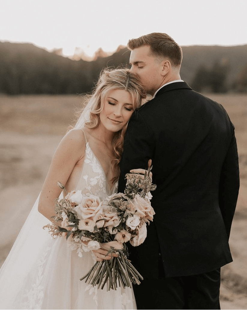 Сouple wearing a white gown and a black suit