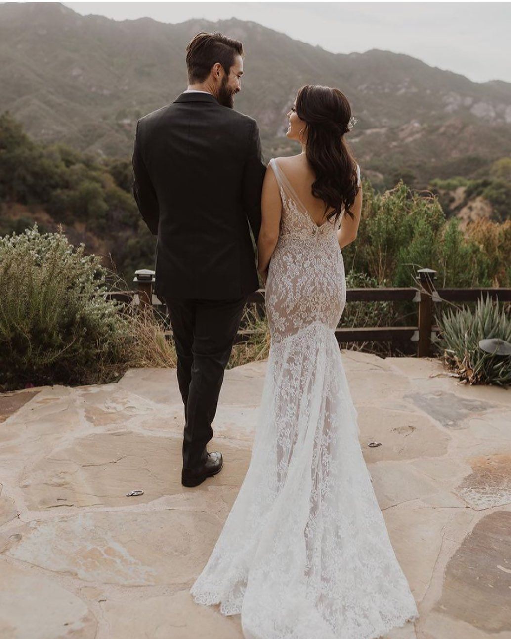 Сouple wearing a white gown and a black suit