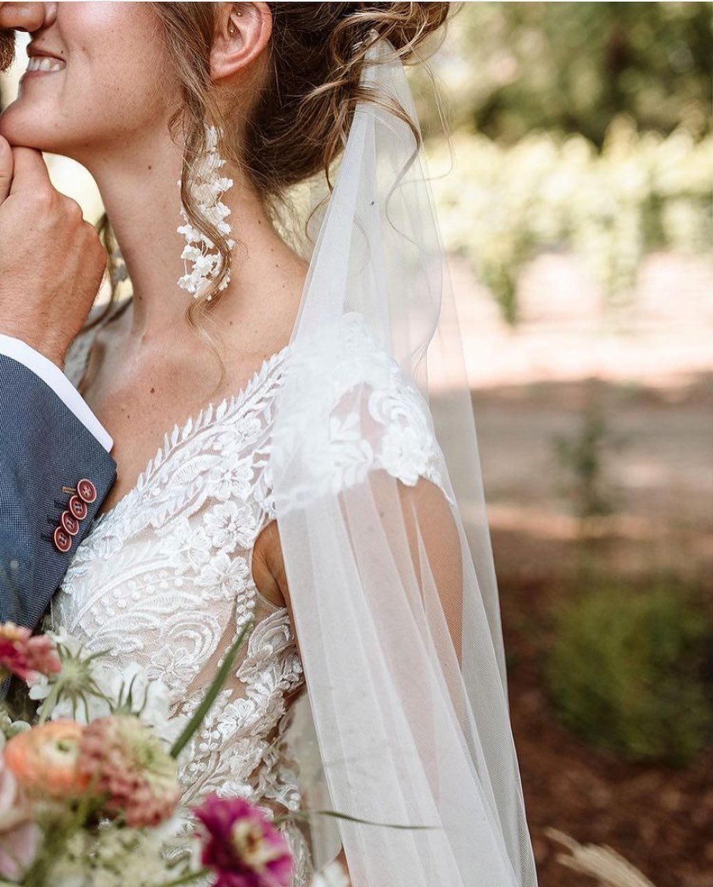 Сouple wearing a white gown and a gray suit