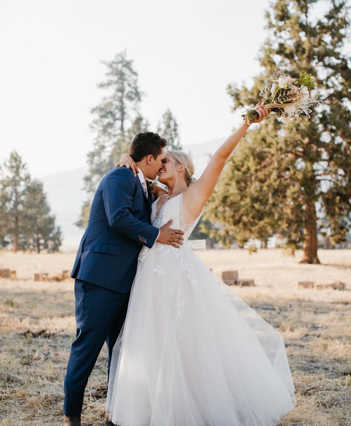 Сouple wearing a white gown and a dark-blue suit