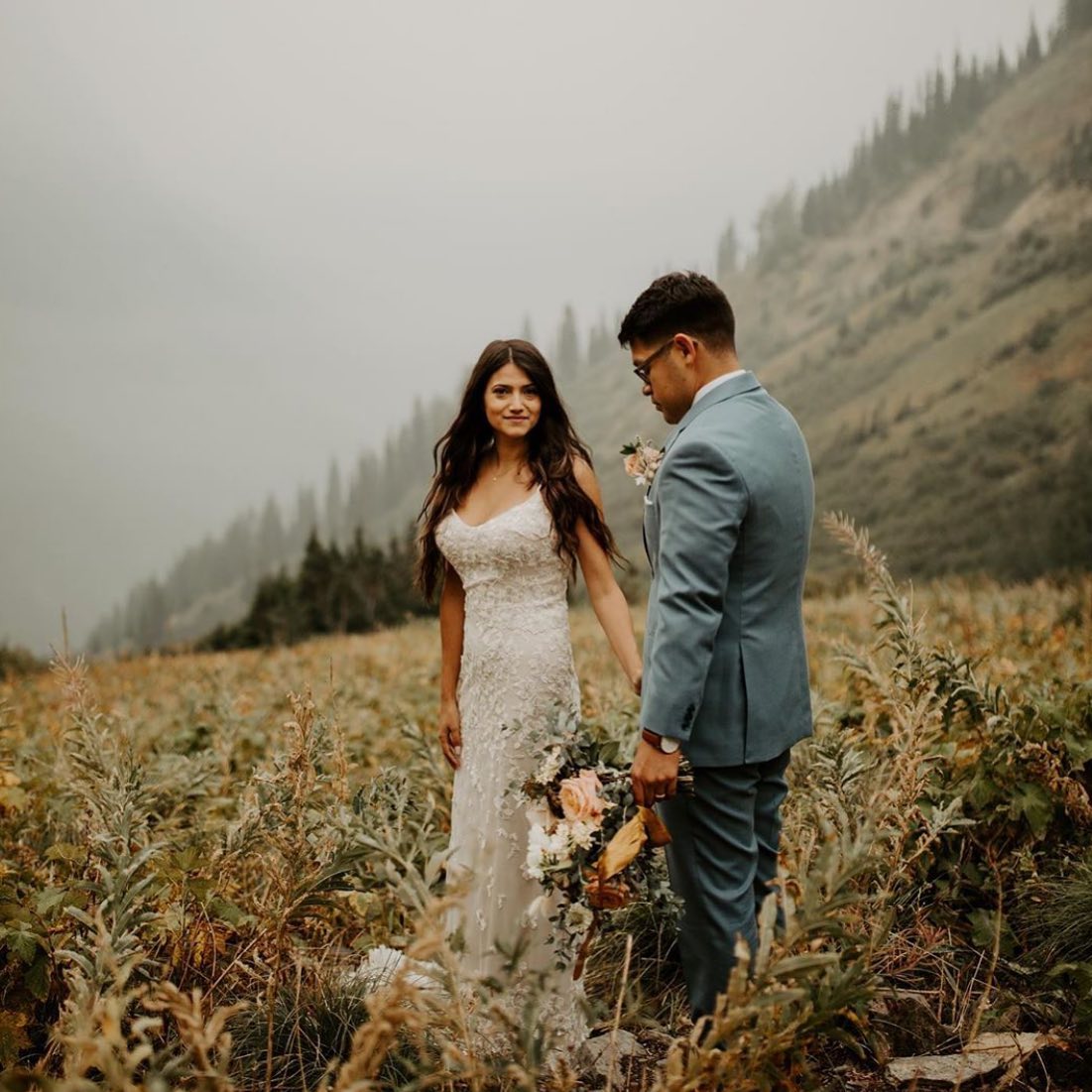 Сouple wearing a white gown and a light-gray suit
