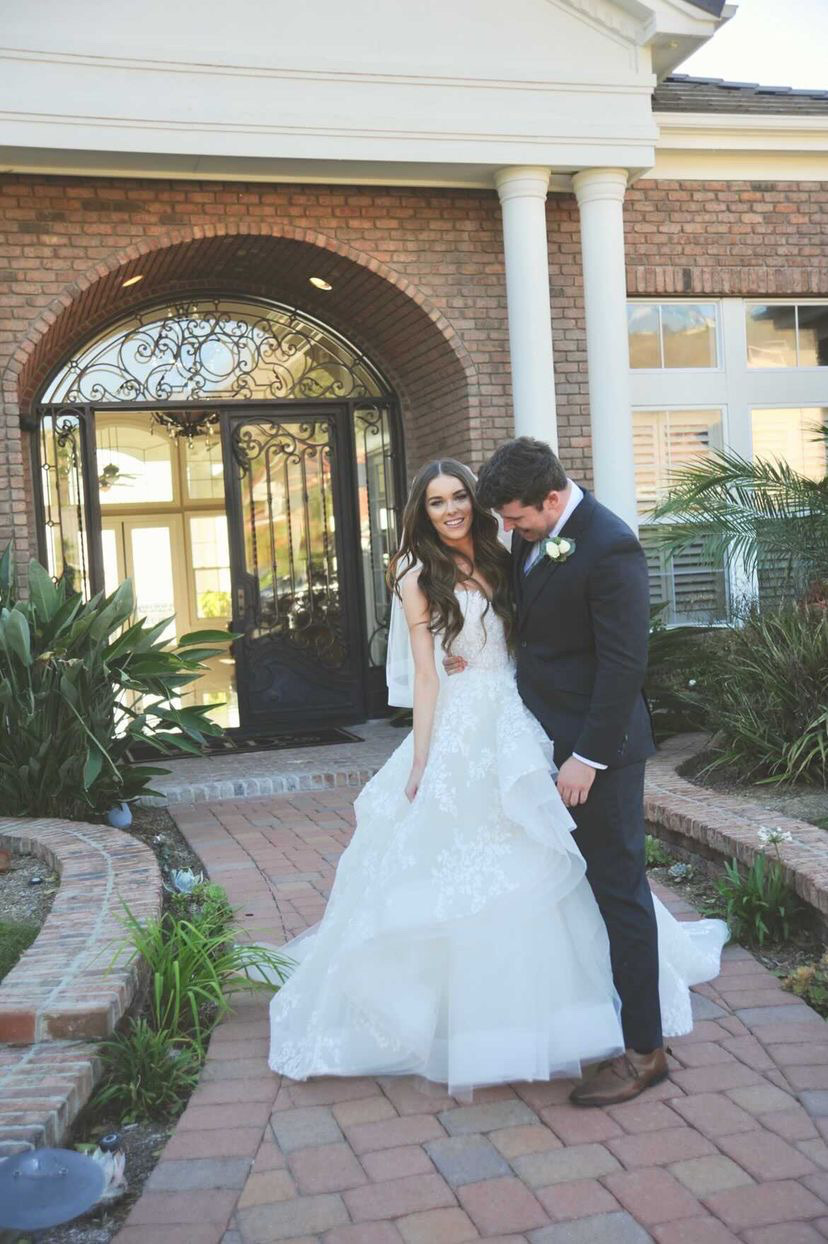 Сouple wearing a white gown and a black suit