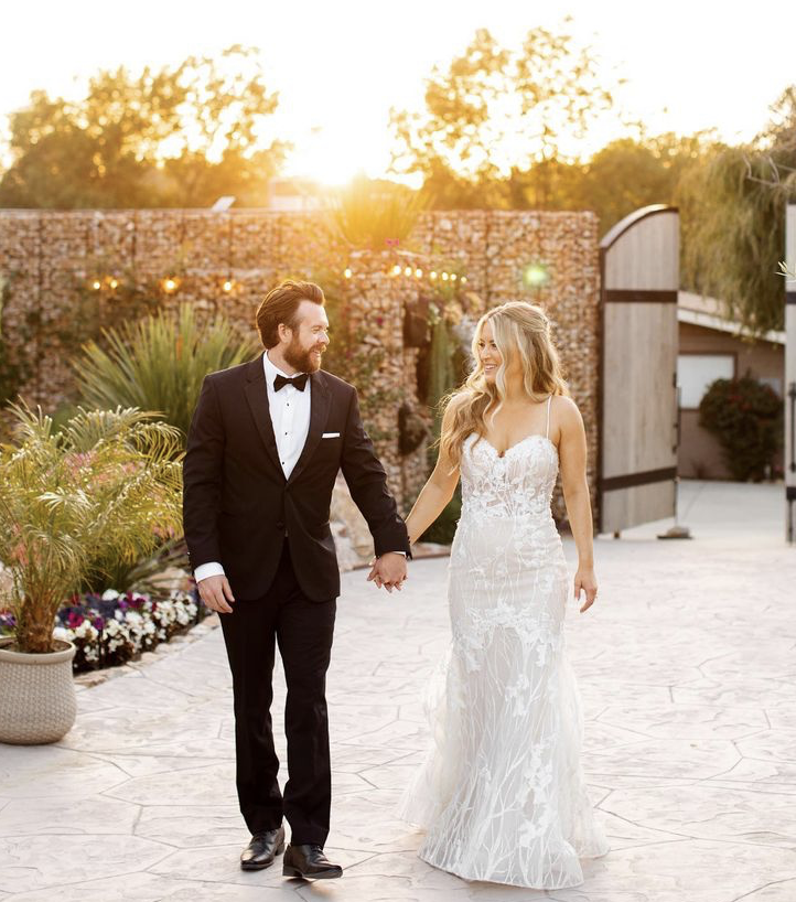Сouple wearing a white gown and a black suit