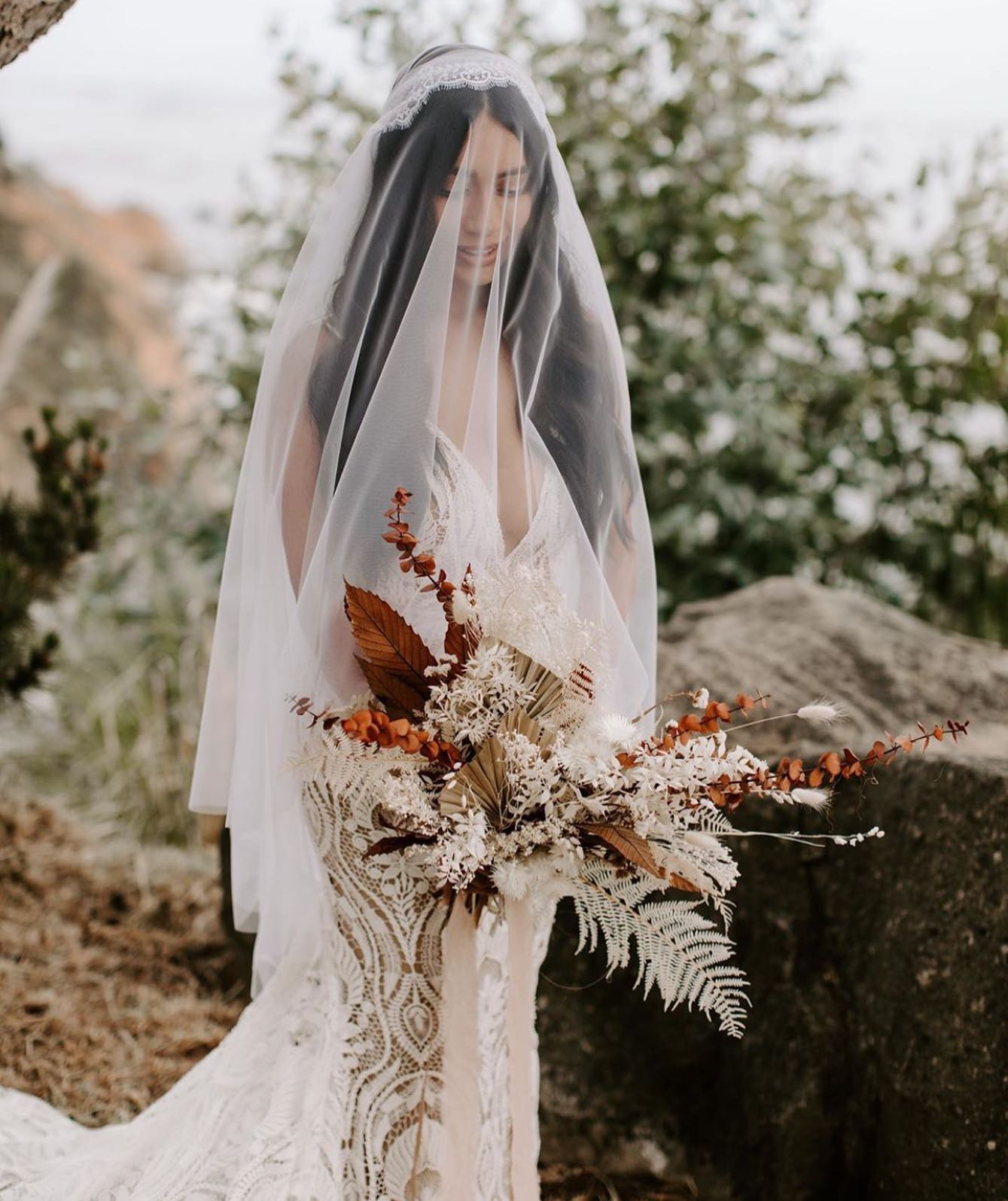 Model wearing a white gown with a flowers